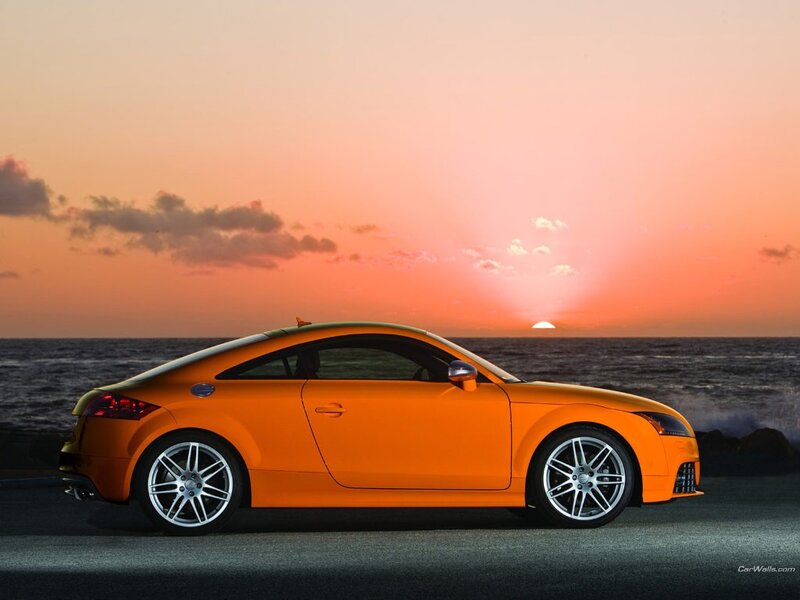 Orange sports car at sunset