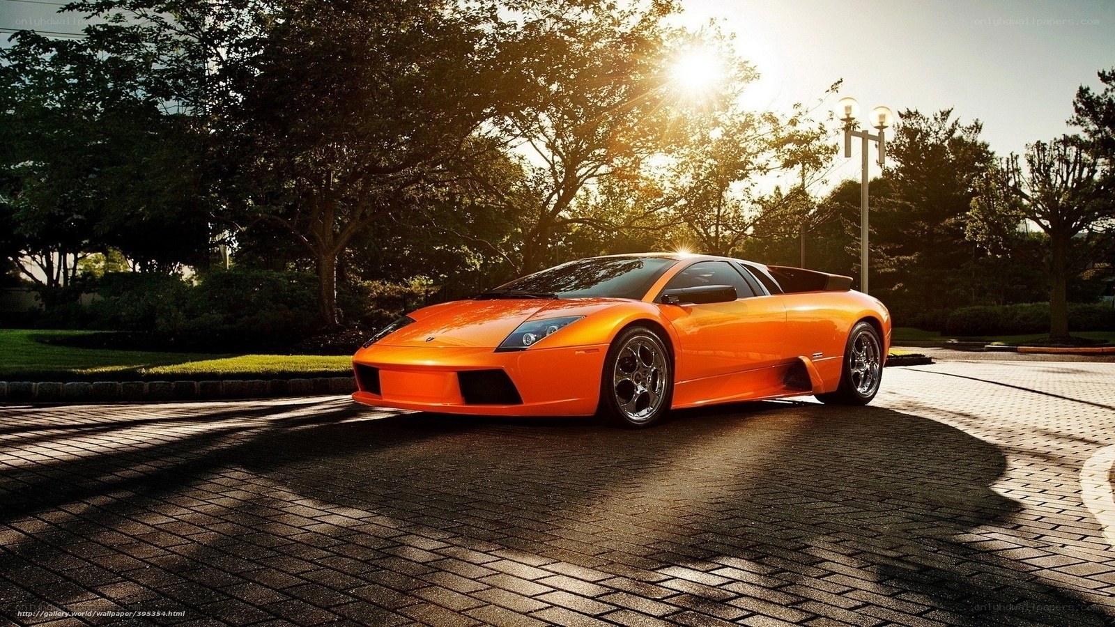 Orange sports car at sunset