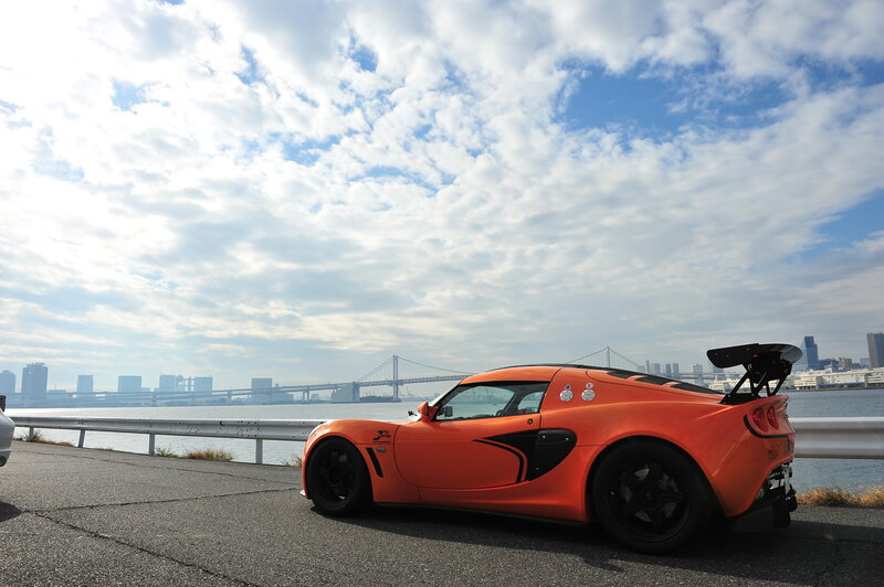 Orange sports car by the water