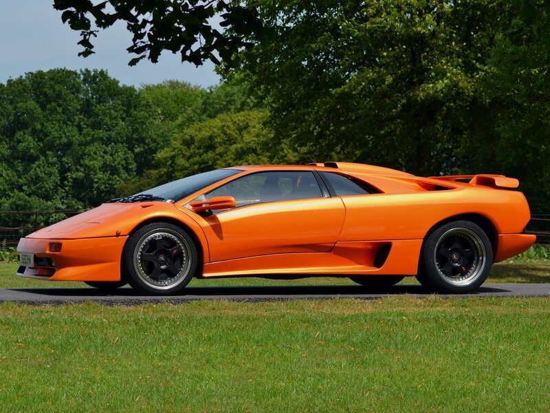Orange Sports Car — Calm, Afternoon, Photograph, Grass, Trees, Road