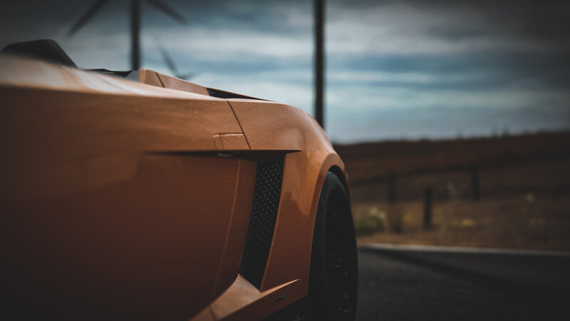 Orange Sports Car — Dramatic, Afternoon, Photograph, Wind Turbine