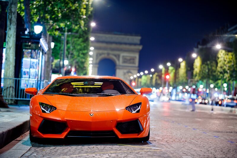 Orange Sports Car — Dramatic, Night, Photograph, Arc De Triomphe, Streetlights, Trees, Cobblestone