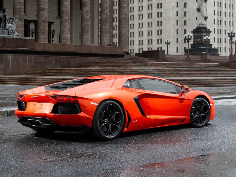 Orange Sports Car — Dramatic, Photograph, Building
