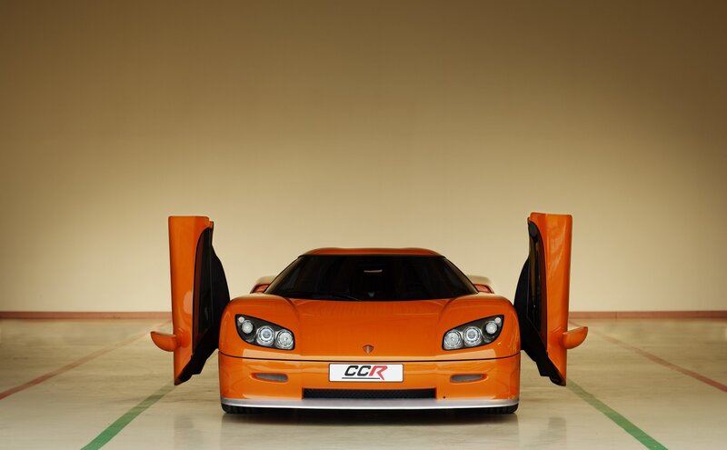 Orange Sports Car — Dramatic, Photograph, Car Doors, License Plate, Garage