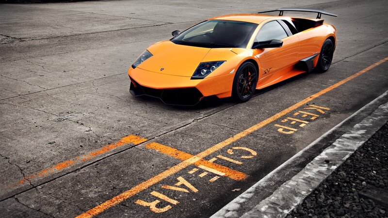 Orange Sports Car — Dramatic, Photograph, Concrete Surface