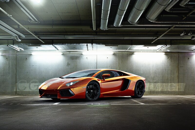Orange Sports Car — Dramatic, Photograph, Concrete Wall, Overhead Pipes