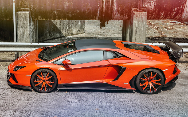 Orange Sports Car — Dramatic, Photograph, Concrete Wall