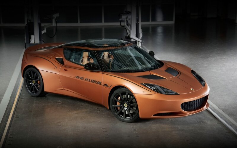 Orange Sports Car — Dramatic, Photograph, Garage, Black Wheels, Black