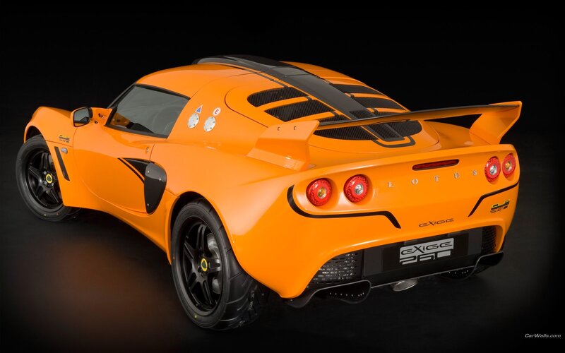 Orange Sports Car — Dramatic, Photograph, Rear Wing, Black Wheels, Carbon Fiber Panels
