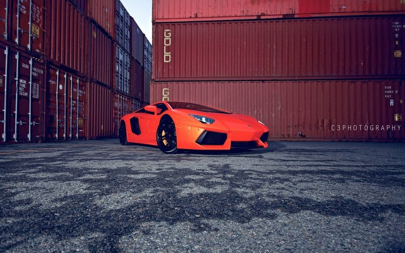 Orange Sports Car — Dramatic, Photograph, Shipping Containers