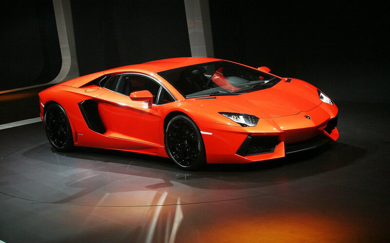 Orange Sports Car — Dramatic, Photograph, Showroom