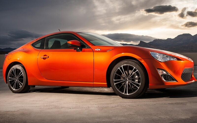 Orange Sports Car — Dramatic, Sunset, Photograph, Mountains, Clouds