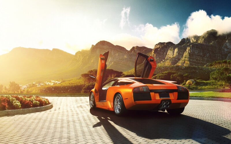Orange Sports Car — Dramatic, Sunset, Photograph, Mountains, Flowers