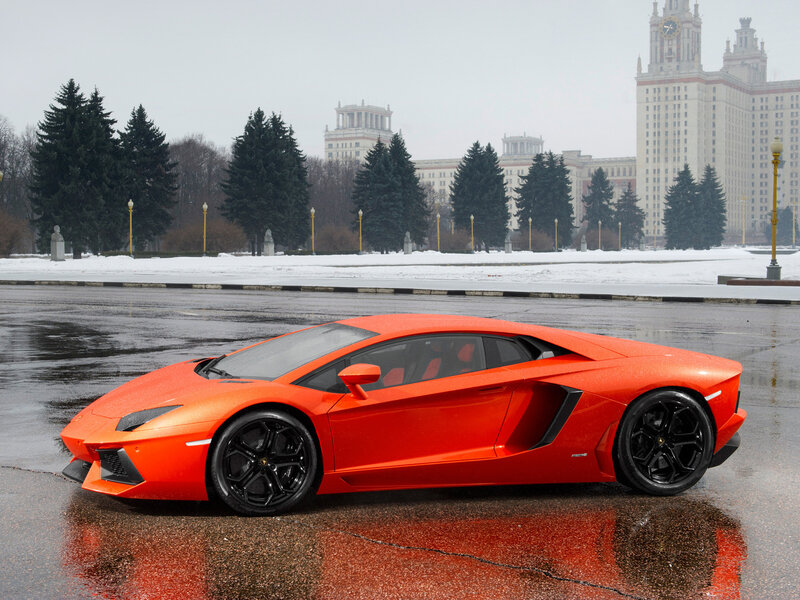 Orange Sports Car — Dramatic, Winter, Photograph, Building