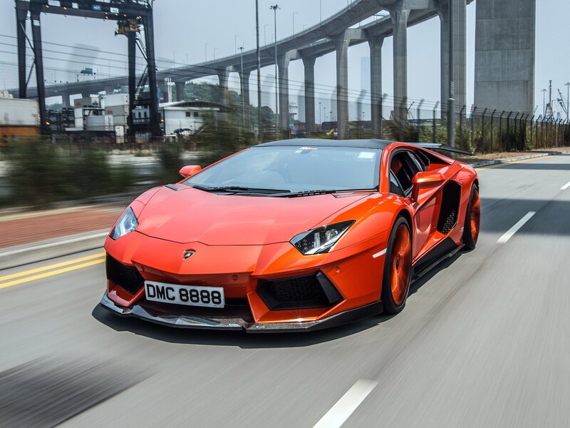 Orange Sports Car — Dynamic, Afternoon, Photograph, Bridge, Road, Container Crane