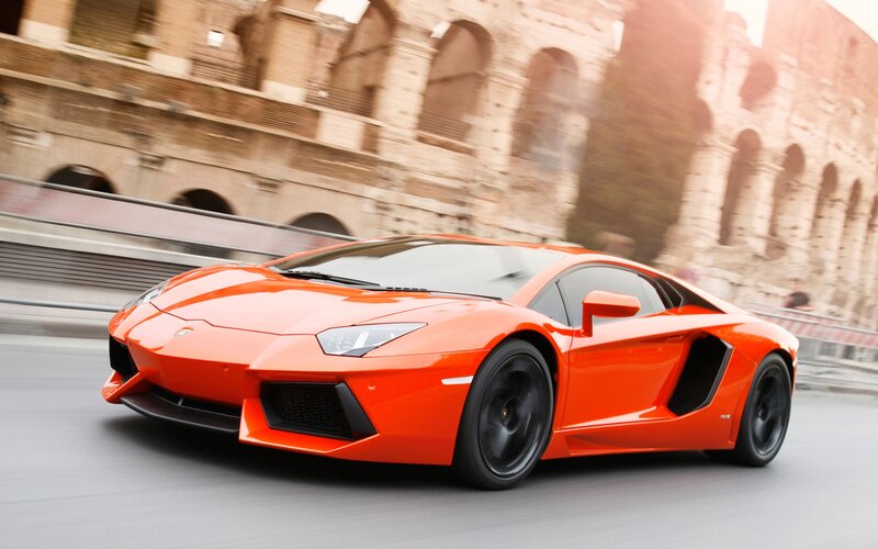 Orange Sports Car — Dynamic, Afternoon, Photograph, Colosseum