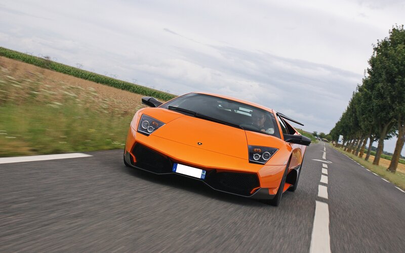 Orange Sports Car — Dynamic, Afternoon, Photograph, Driver, Road, Trees, Field