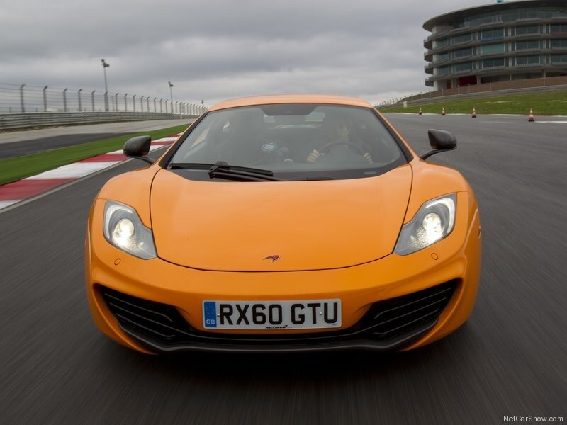 Orange Sports Car — Dynamic, Afternoon, Photograph, Race Track, Building