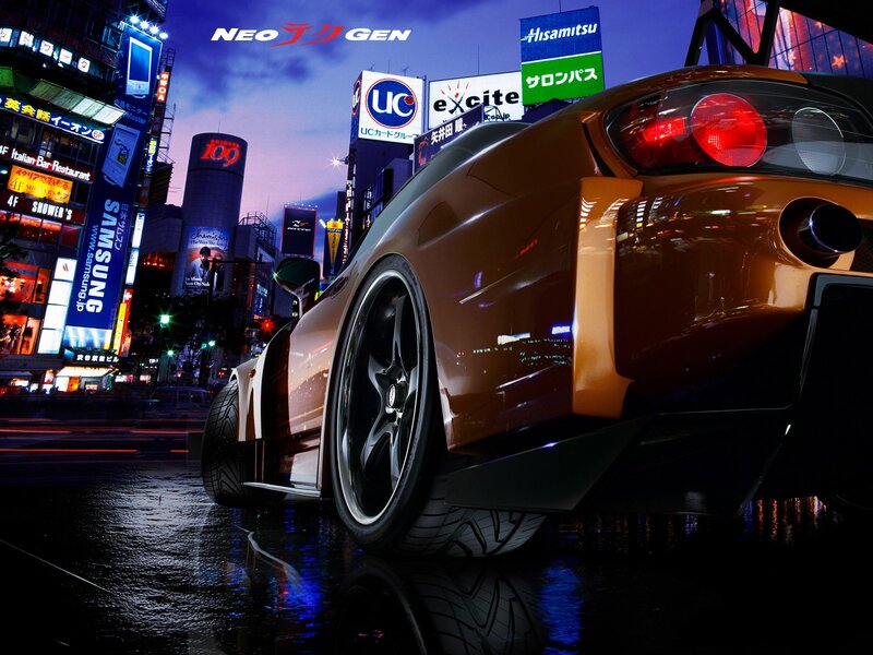 Orange sports car in city at night