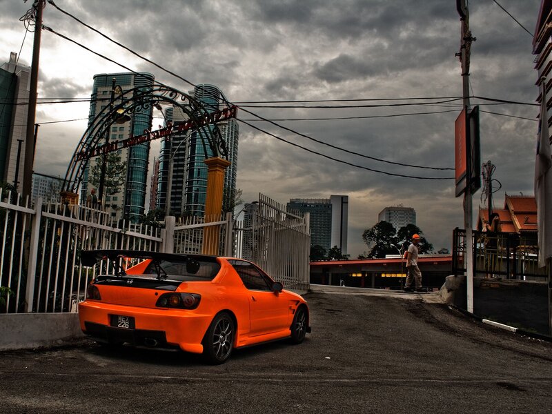 Orange sports car in city street