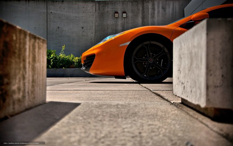 orange sports car in concrete setting