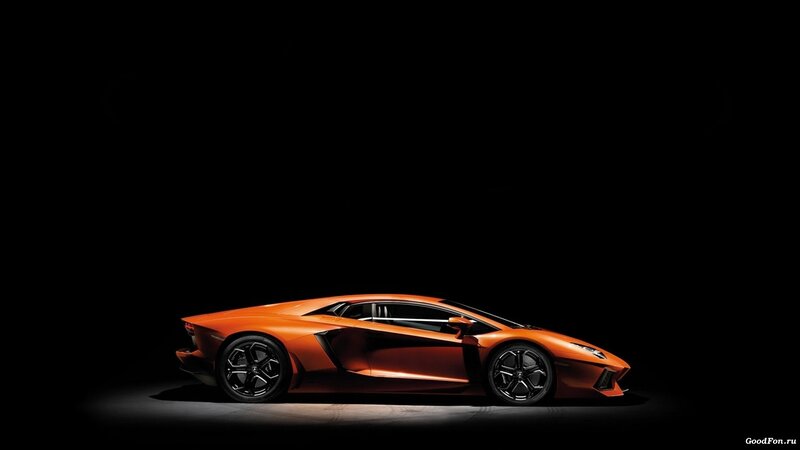 orange sports car in dark studio
