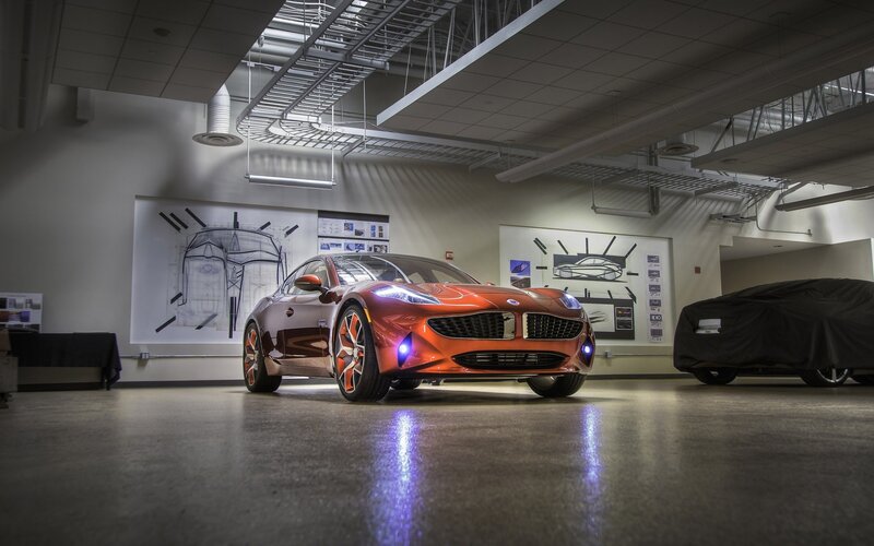 Orange sports car in design studio