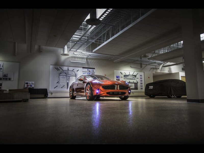 Orange sports car in design studio
