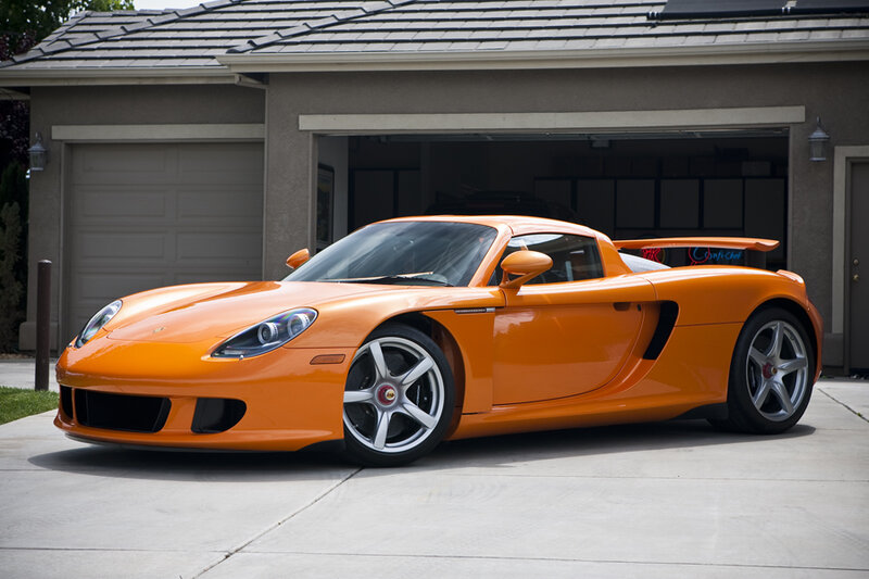 orange sports car in driveway