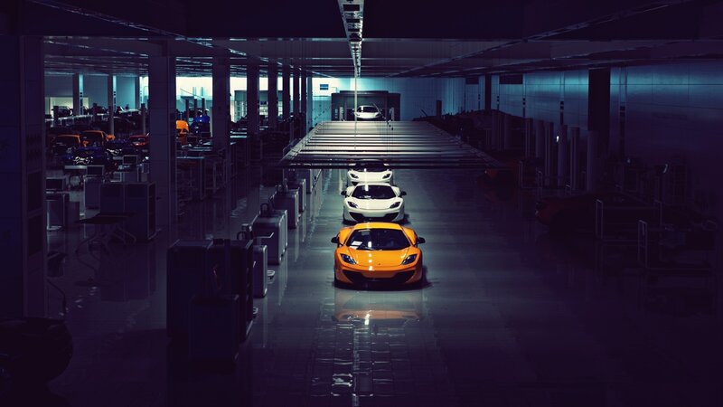Orange Sports Car in Factory — Dramatic