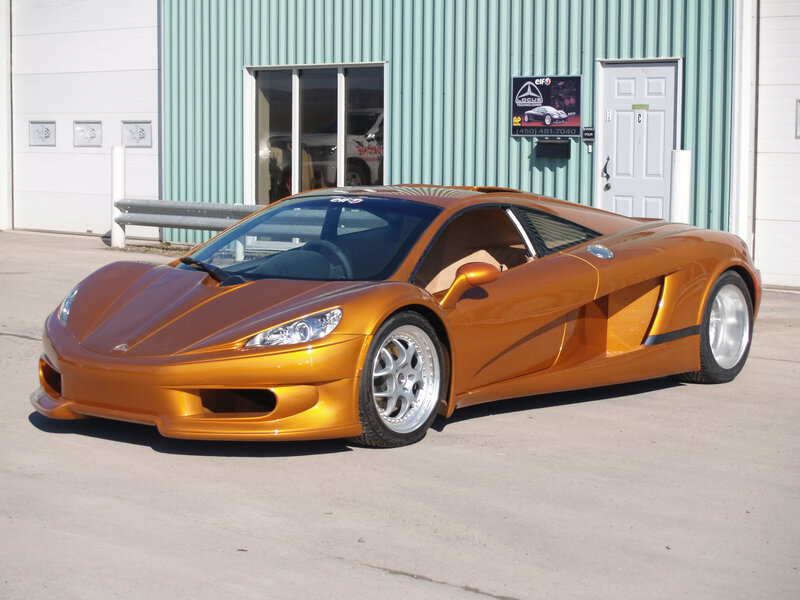 orange sports car in front of garage