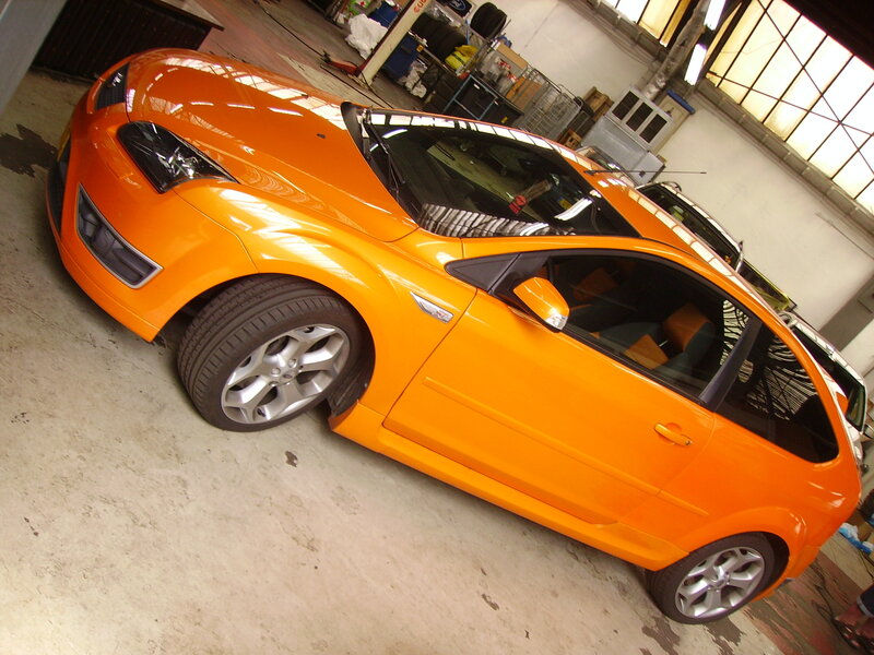 Orange sports car in garage