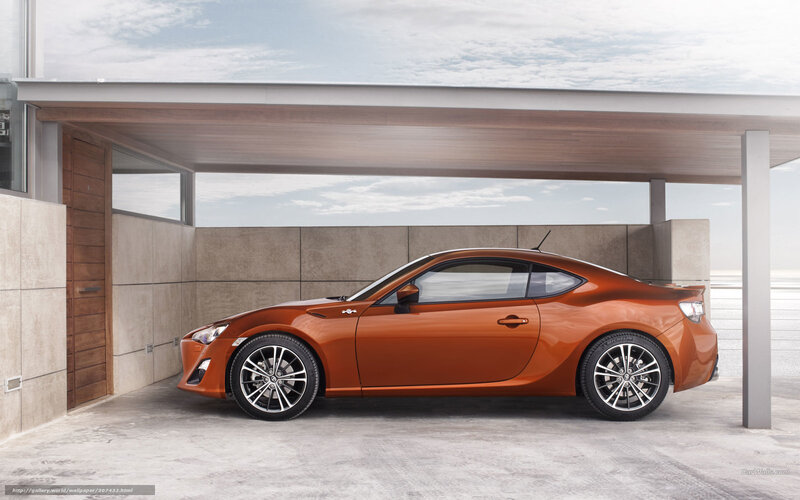 orange sports car in garage