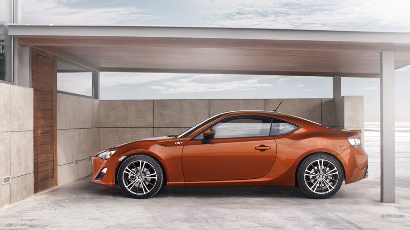 orange sports car in garage