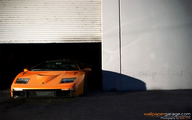 orange sports car in garage