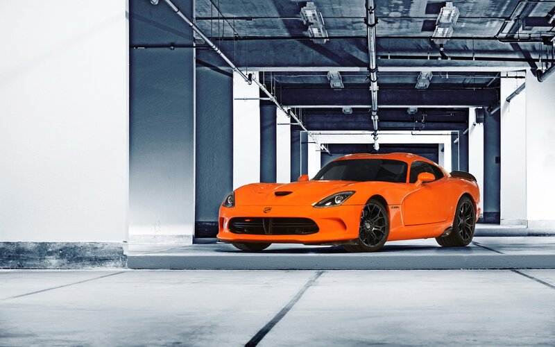 Orange sports car in garage