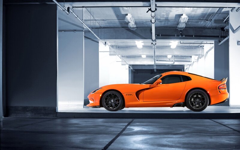 Orange sports car in garage