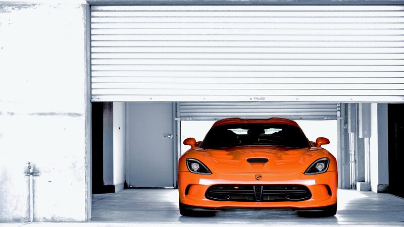 Orange sports car in garage