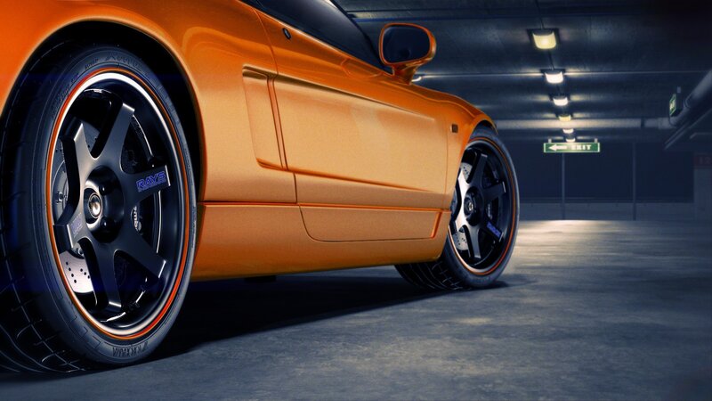 orange sports car in garage