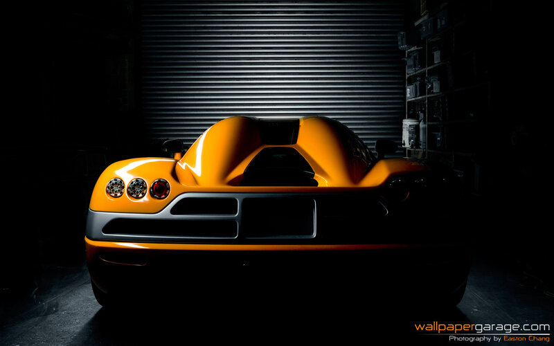 orange sports car in garage