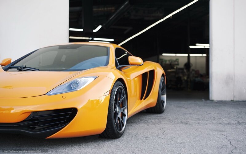 orange sports car in garage