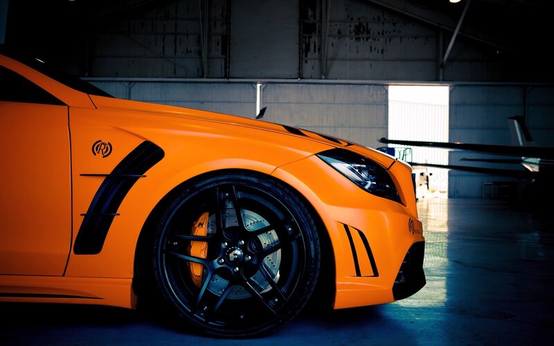orange sports car in hangar