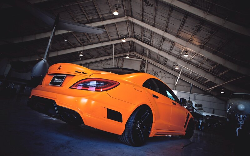 orange sports car in hangar