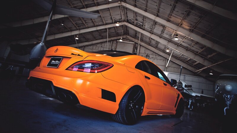 orange sports car in hangar