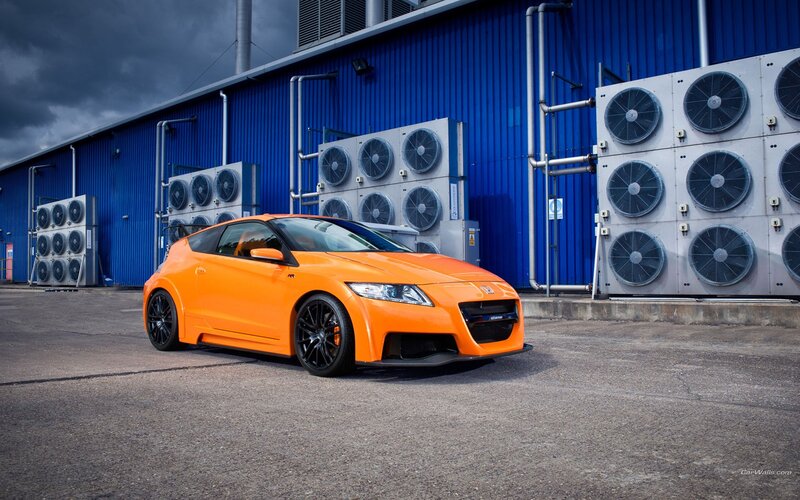 orange sports car in industrial setting