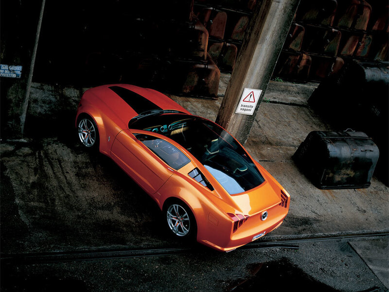 Orange sports car in industrial setting