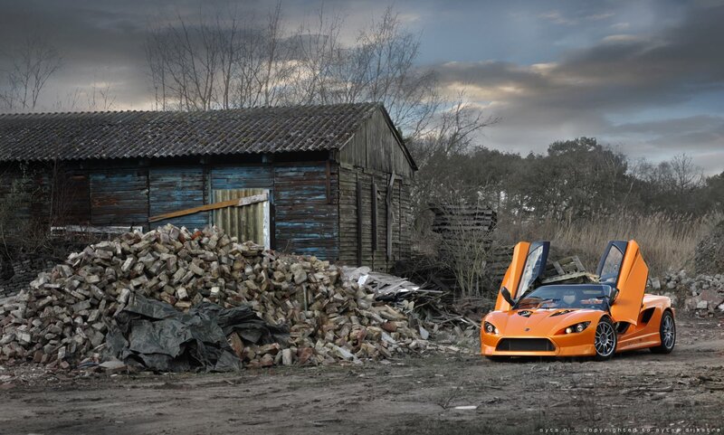 Orange sports car in junkyard