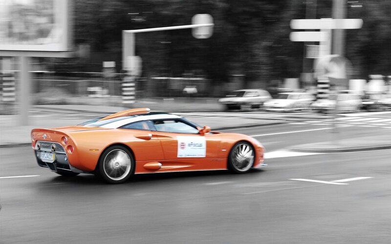 Orange sports car in motion