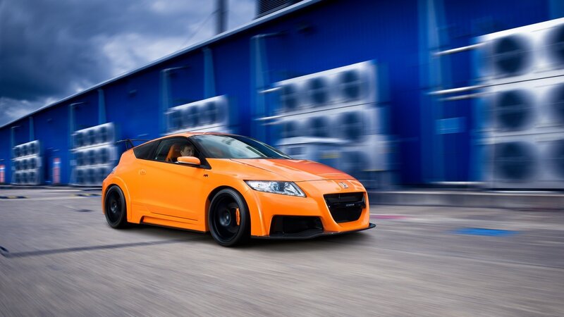 Orange sports car in motion