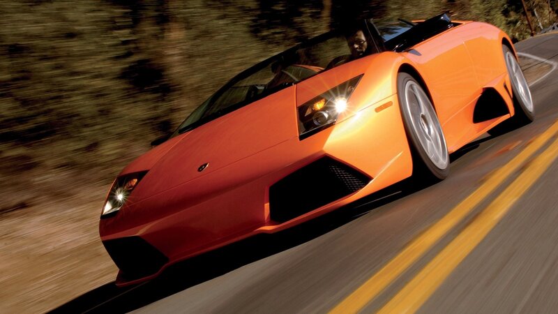 orange sports car in motion